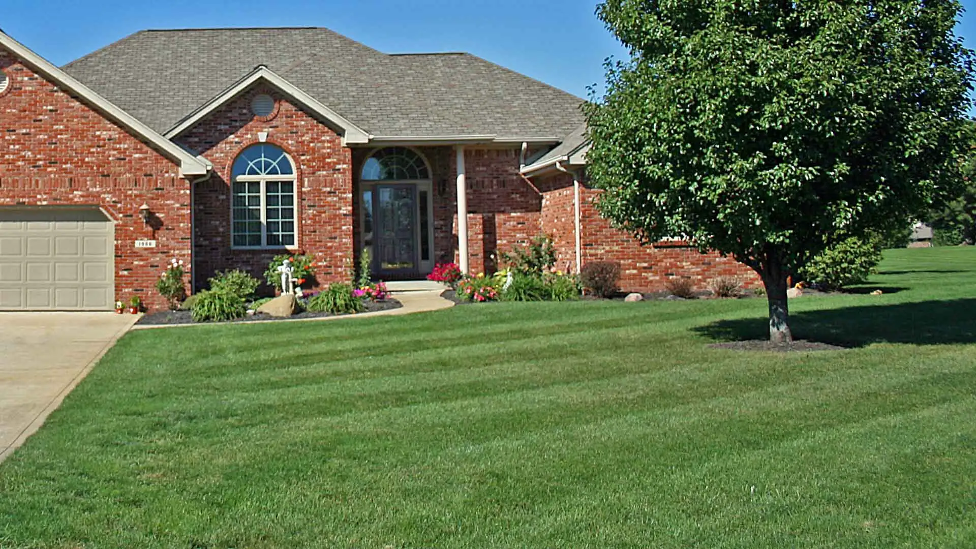 Well maintained lawn and landscaping at residential property.
