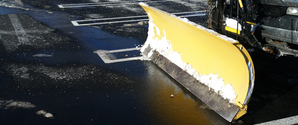 A yellow snow plow attached to our company truck for snow removal in Westfield, IN. 